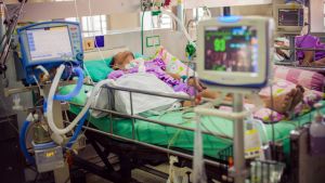 Person mobilising with a physiotherapist at home