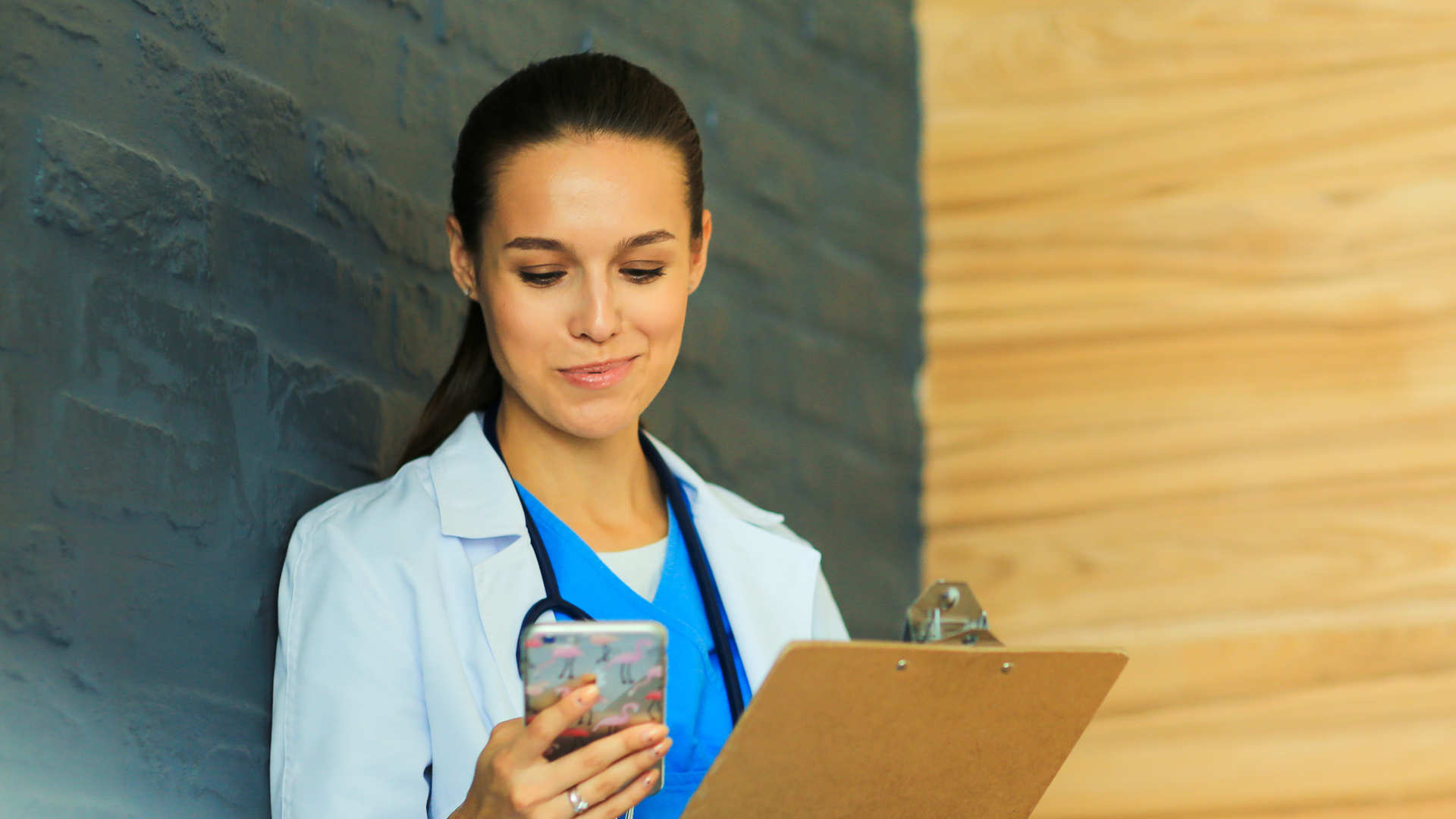 Doctor reading Critical Care Reviews on her mobile phone