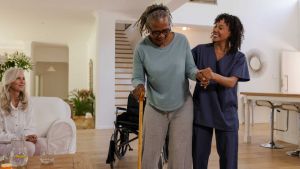 Person mobilising with a physiotherapist at home