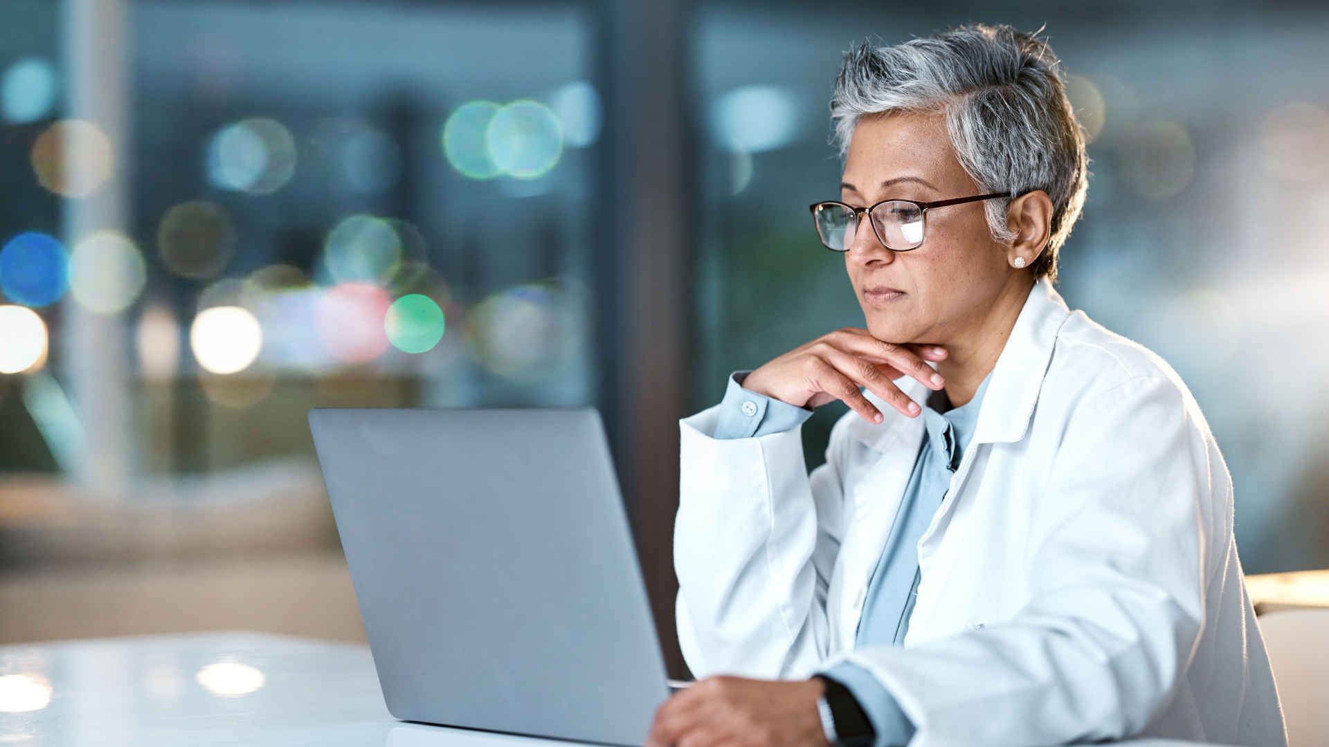 Doctor reading on a laptop