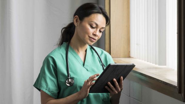 Doctor reading tablet